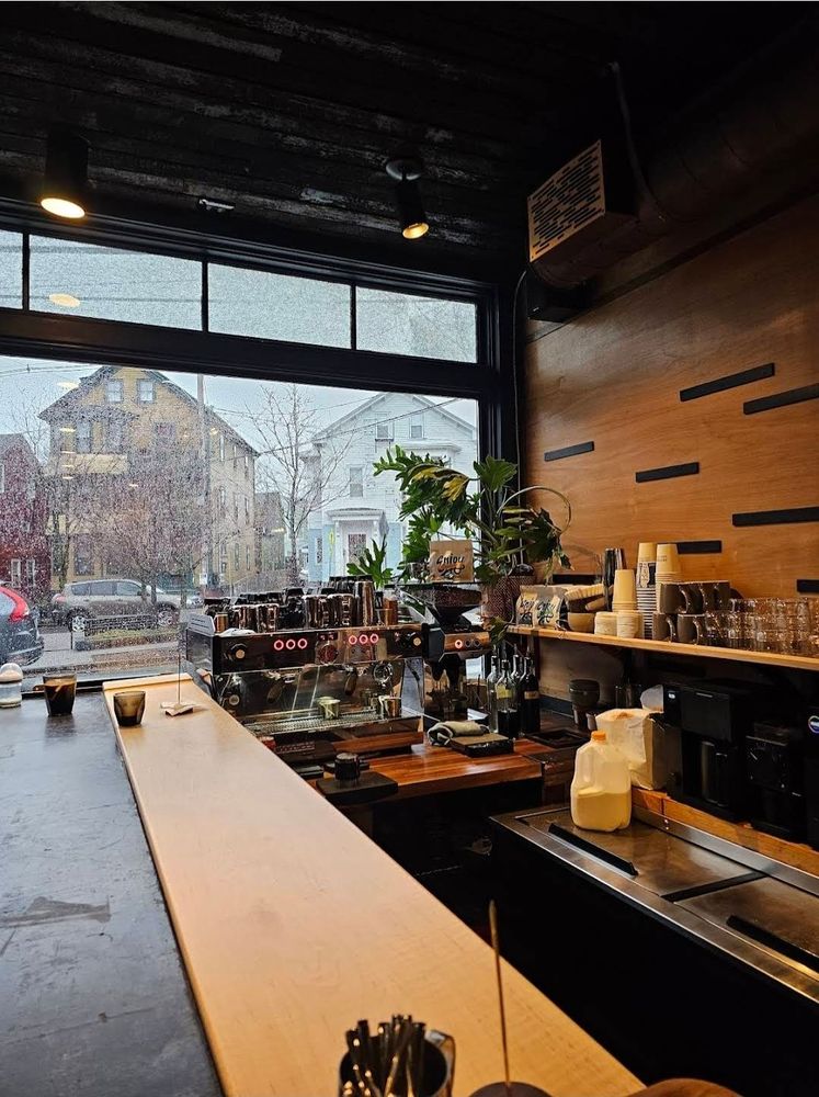 The bar at Reprise — espresso machine and warm wood counter